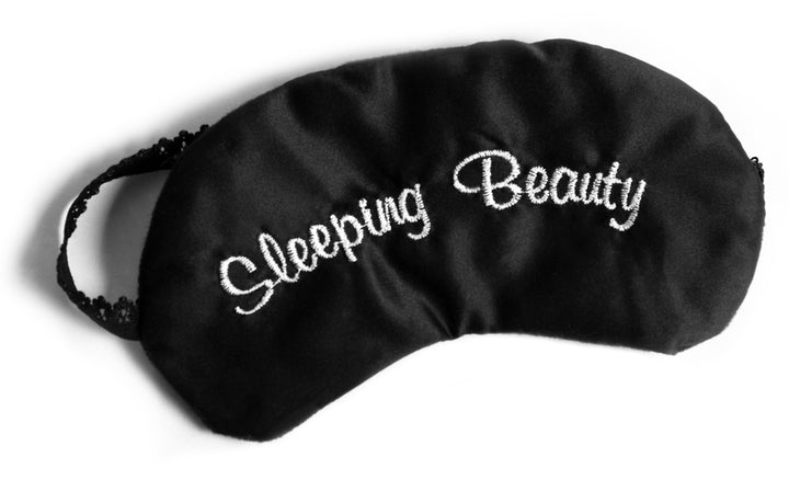 Black Sleeping Eye Mask with embroidered sleeping beauty stitched into silk material. Sleep eye mask with a black lace head band