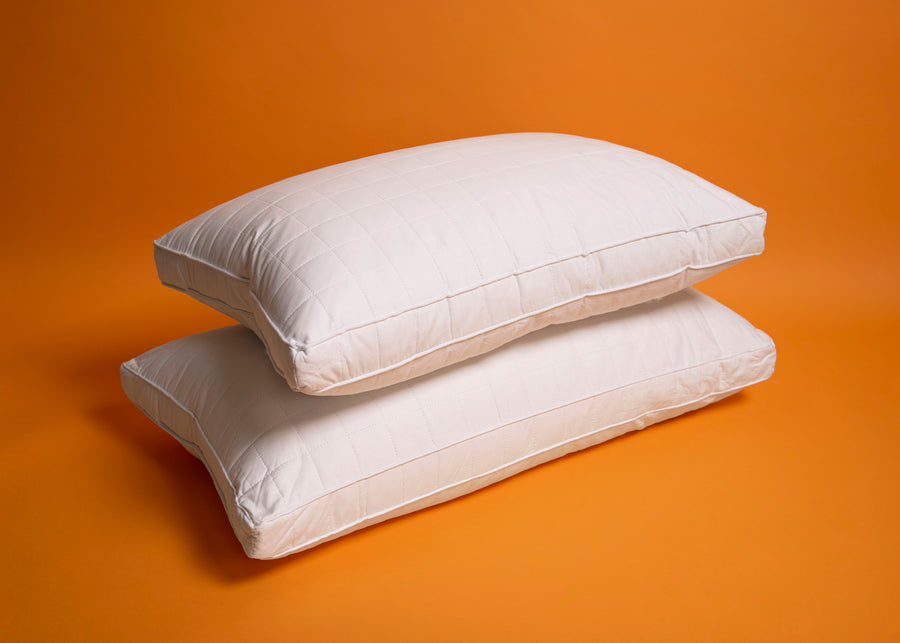 premium gusseted white quilted silk pillows stacked