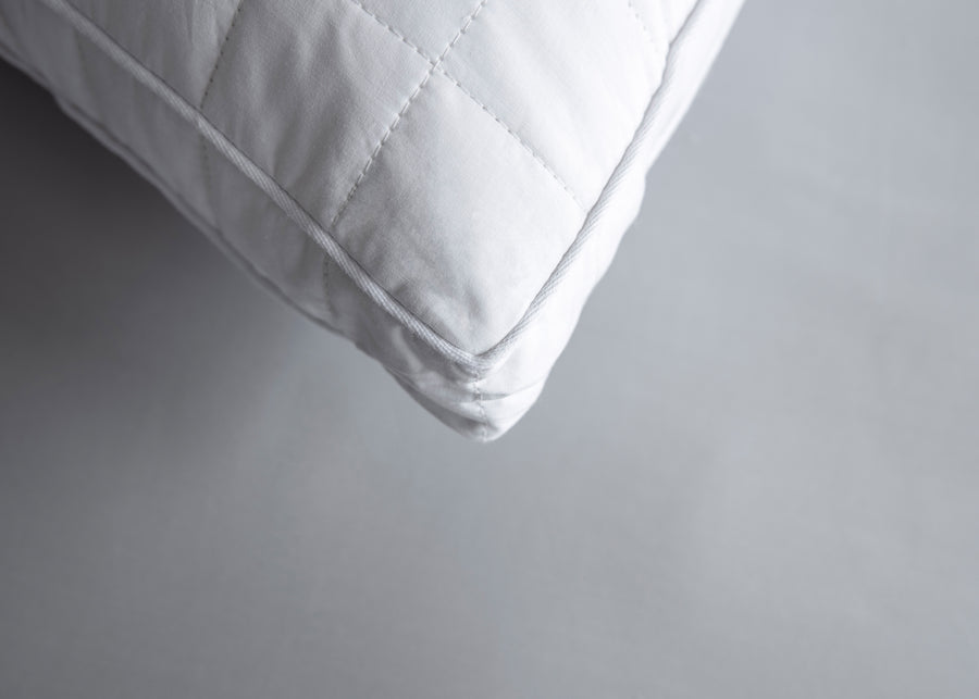 premium gusseted white quilted silk pillow corner close up