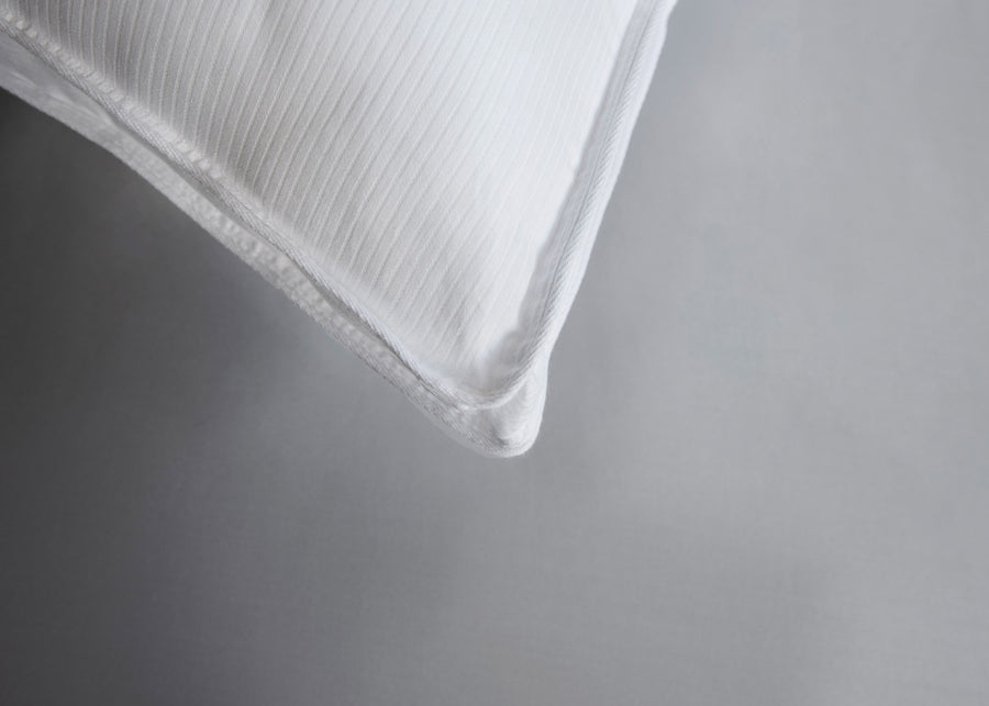 corner close up of gusseted white cotton pillow